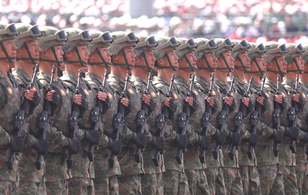 Xi reviews troops, reiterates peaceful development